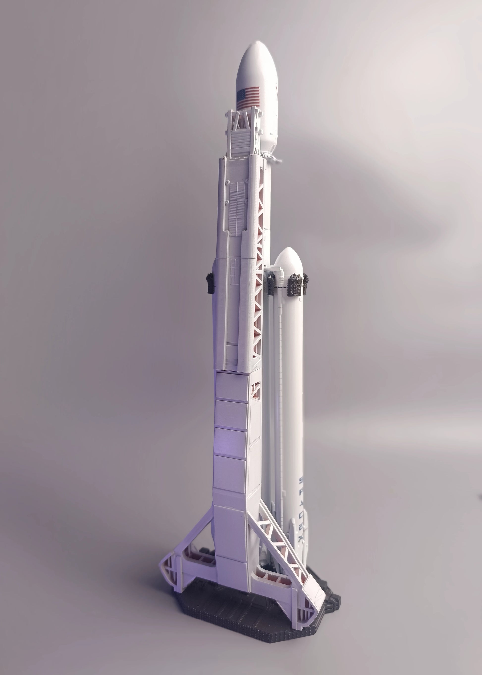 SpaceX Falcon Heavy on the launch table, rear view, detailed launch tower. Model in 1:200 scale